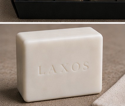 White goat milk soap bar embossed with LAXOS